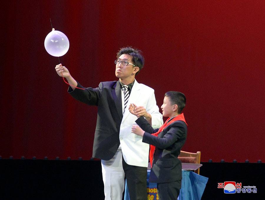 Mr bottle performing in Pyongyang on stage with a volunteer