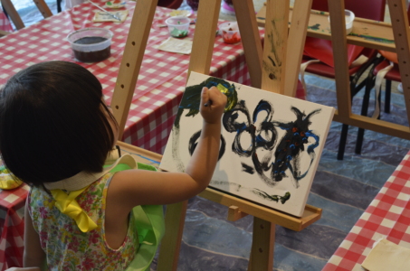 Kids doodling on the canvas for art jam activity