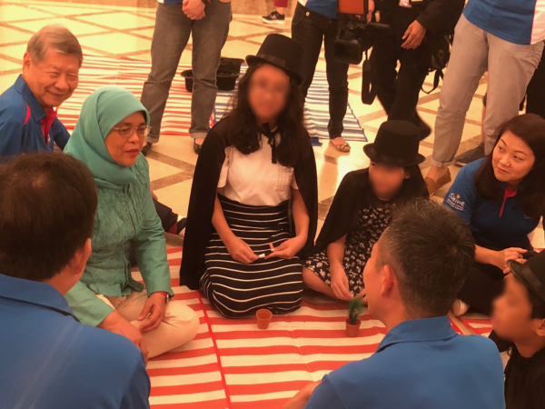 Singapore President Halima Yacob interacting with the children from Singapore Children's Society after watching their magic show.