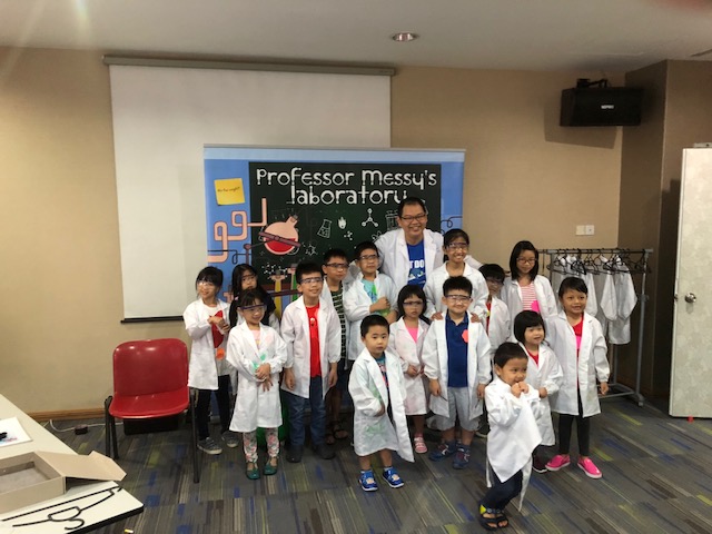 Children taking a photo with our science backdrop