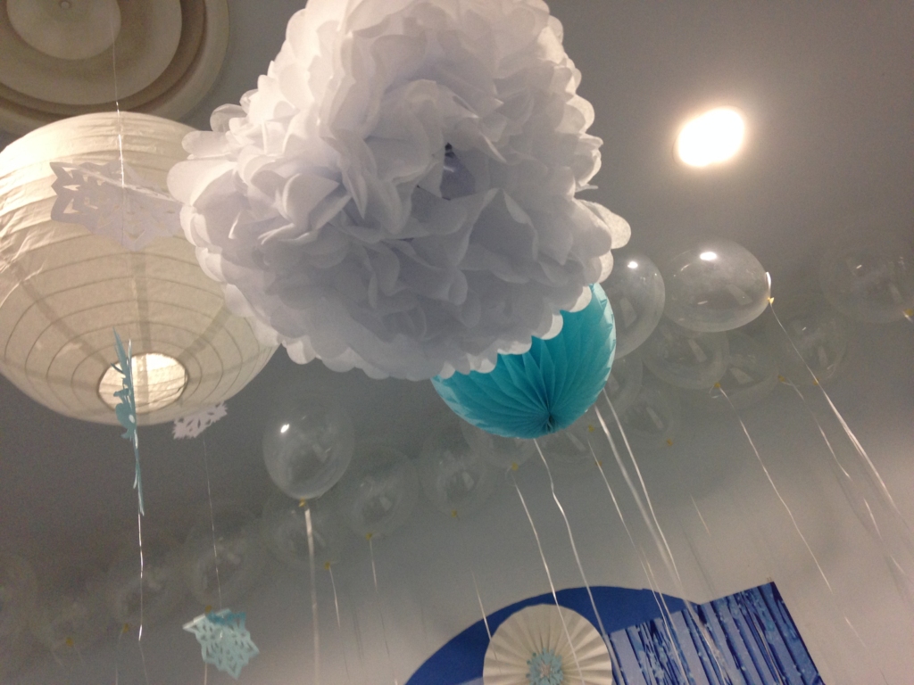 frozen decoration ideas: hang white and blue paper balls and lanterns from the ceiling