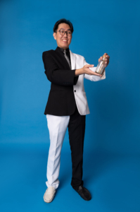 Singapore magician, Mr Bottle holding a bottle