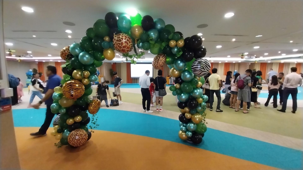 green balloon arch for sustainability bring your children to work event