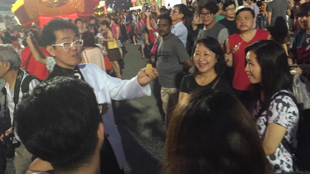 Mr Bottle performing close-up strolling magic at river hongbao